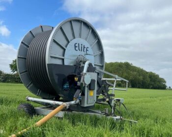 A grey Irrimec irrigation reel in a field